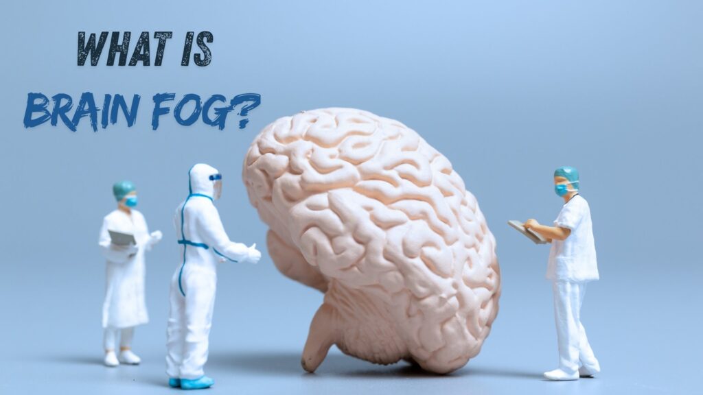 Three doctors in medical attire studying a large model of a human brain with the text "What is Brain Fog?"